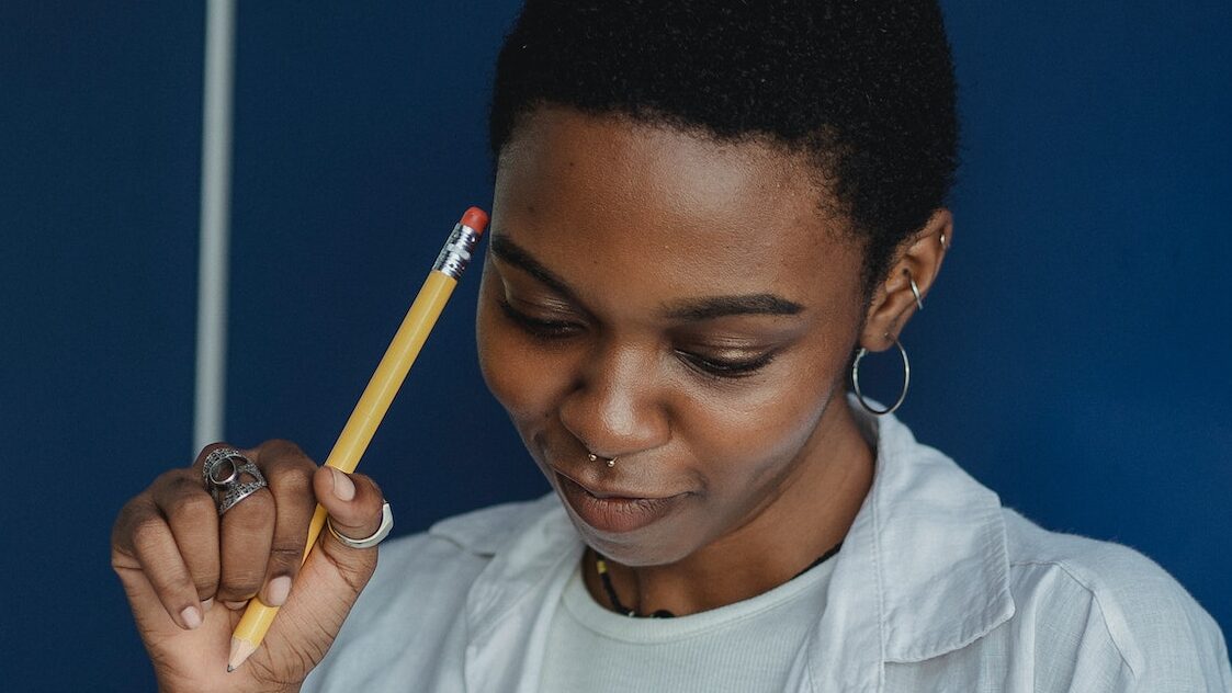 Ragazza concentrata mentre ripete ciò che ha studiato per memorizzare velocemente e ricordare meglio in modo da ottimizzare il proprio tempo di studio.