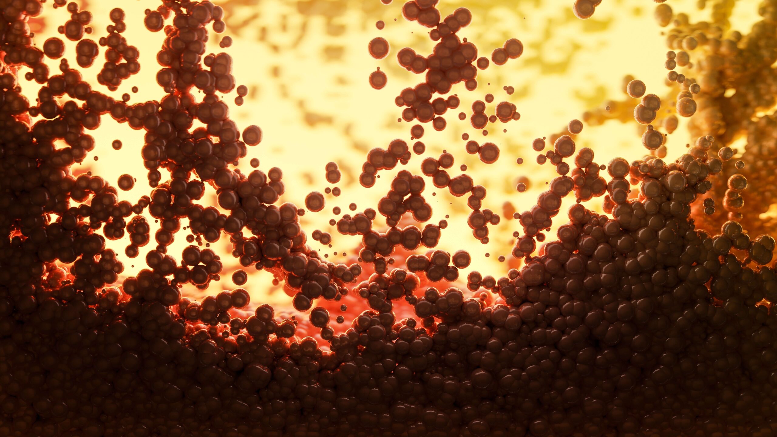 Sfondo giallo. In primo piano delle sfere scure che vanno dal basso (in cui sono compatte e concentrate) con colore nero, all'alto con sfumature perlescenti rosse.